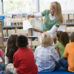 teacher reading book to young children. 50 must read books for pre-k